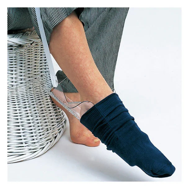 Person using a sock aid device to put on a navy sock, home care medical supply