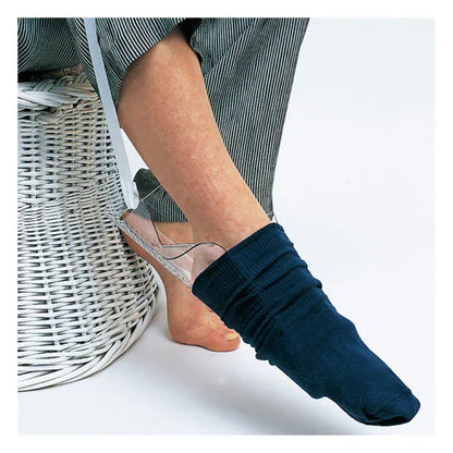 Person using a sock aid device to put on a navy sock, home care medical supply