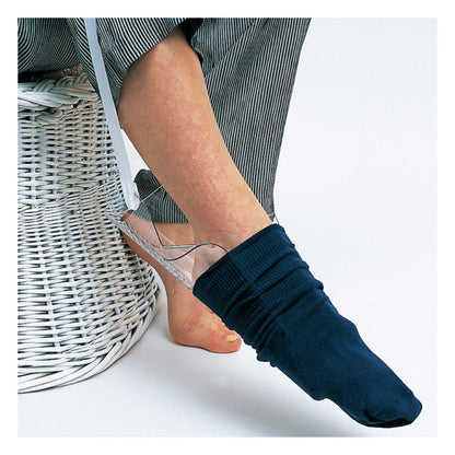 Sock aid device helping person put on navy sock, elderly home care mobility aid