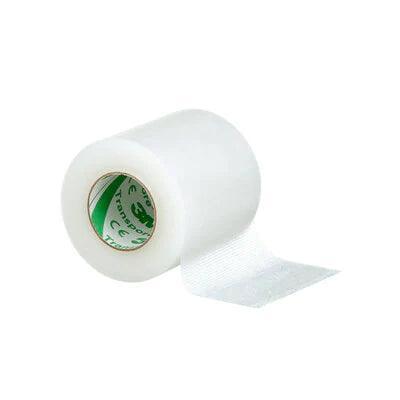 Clear medical adhesive tape roll, unrolled on white background, home care supply