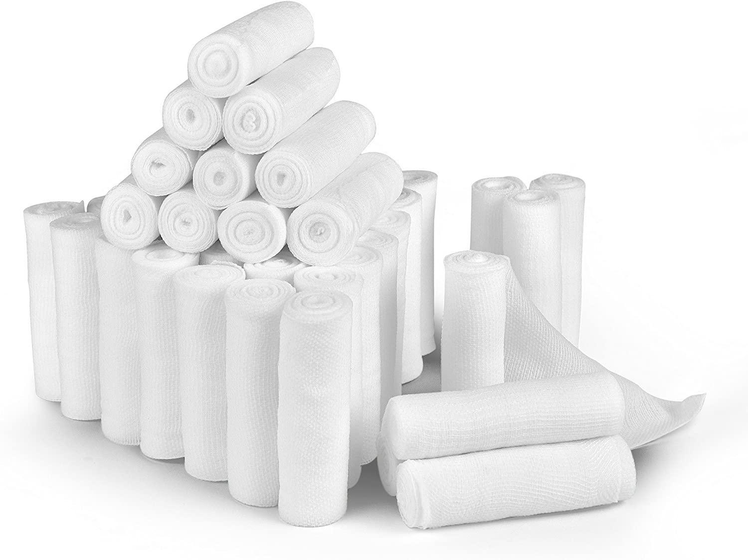 Sterile medical gauze bandage rolls stacked on white background