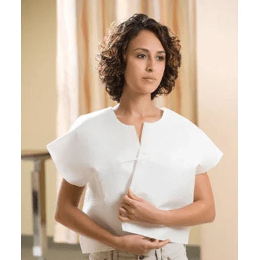 Woman wearing disposable medical exam gown in clinical setting