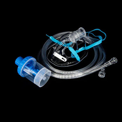 Oxygen mask with tubing and blue nebulizer cup for respiratory therapy on black background
