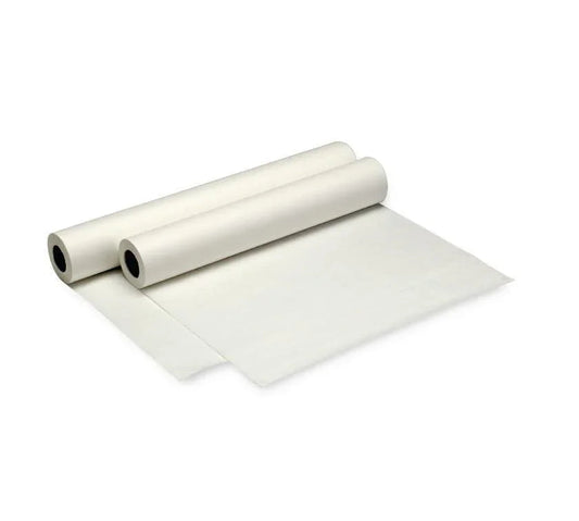Two medical exam table paper rolls unrolling on white background
