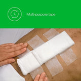 Medical paper surgical tape securing a large gauze pad on skin, hands applying tape, multi-purpose use