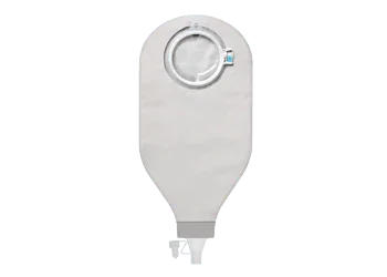 Ostomy drainage bag with adhesive ring for home care and medical use on grey background