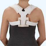 Person wearing a back posture corrector brace for upper back and shoulder support
