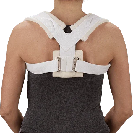 Person wearing a white clavicle brace posture corrector on back, home medical support