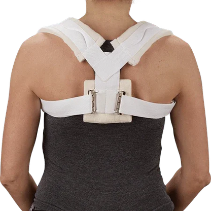 Person wearing a white clavicle brace posture corrector on back, home medical support
