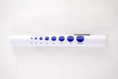 white medical pupil gauge pen with blue measurement circles for eye assessments