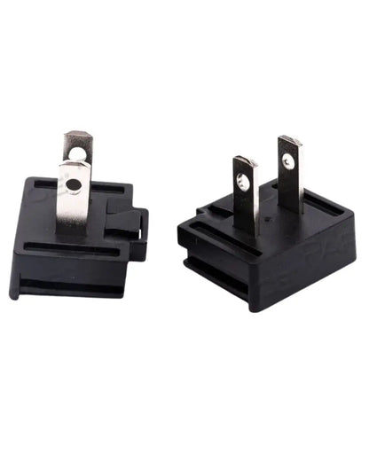 Black two-prong electrical plug adapters for medical equipment on white background