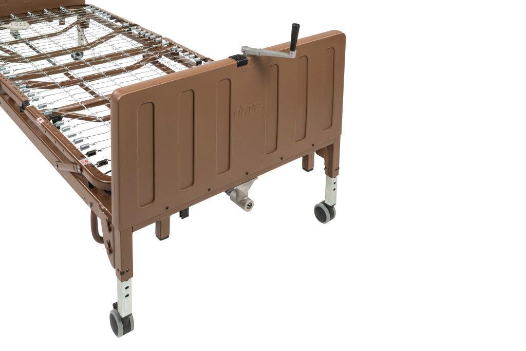 Electric low height hospital bed with metal frame and adjustable height on caster wheels