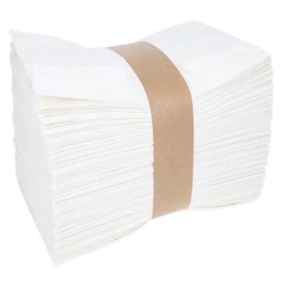 Stack of white disposable paper napkins bundled for medical and home care use