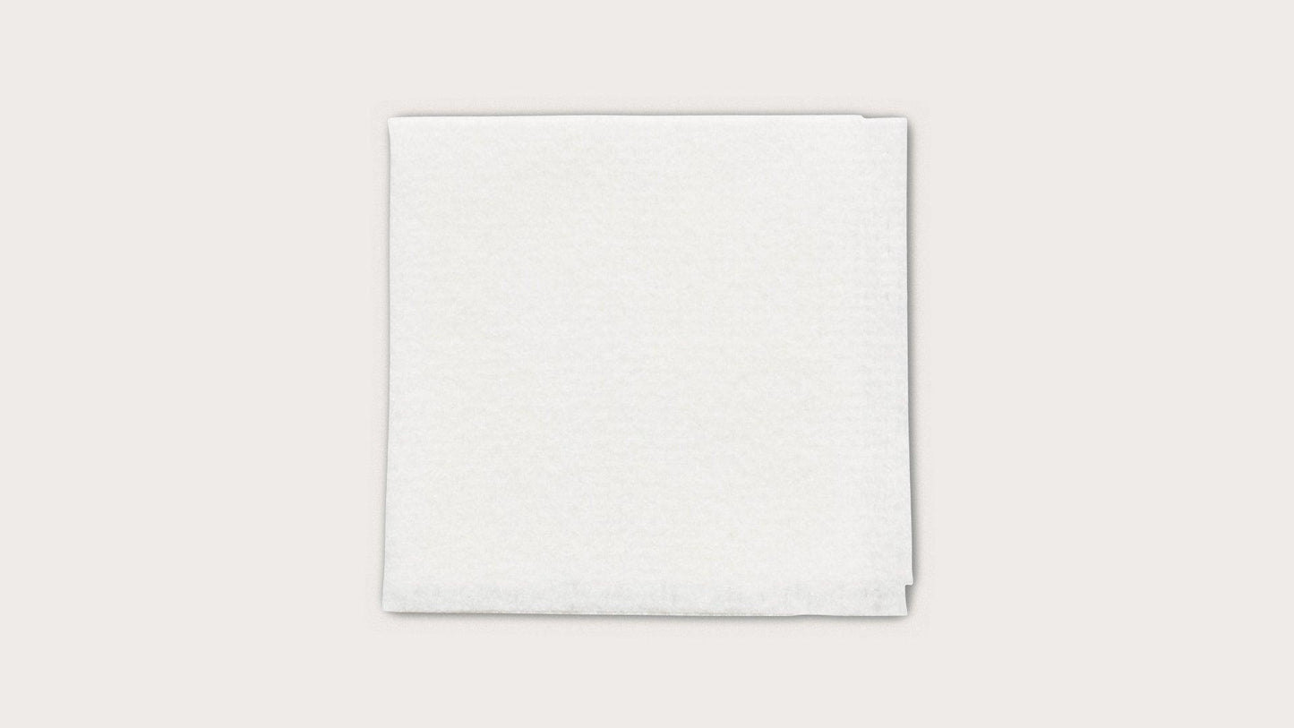 Sterile white medical gauze pad on a plain background for wound care