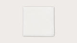 Sterile white medical gauze pad on a plain background for wound care