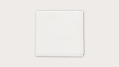 Sterile white medical gauze pad on a plain background for wound care