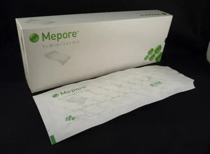 Mepore sterile wound dressing 9 x 30 cm box and individual bandage on black background