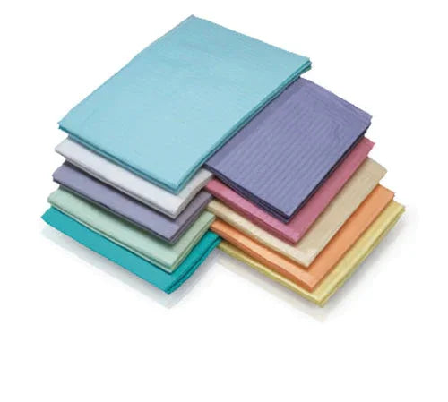 Stack of colorful disposable medical underpads on white background, home care supplies
