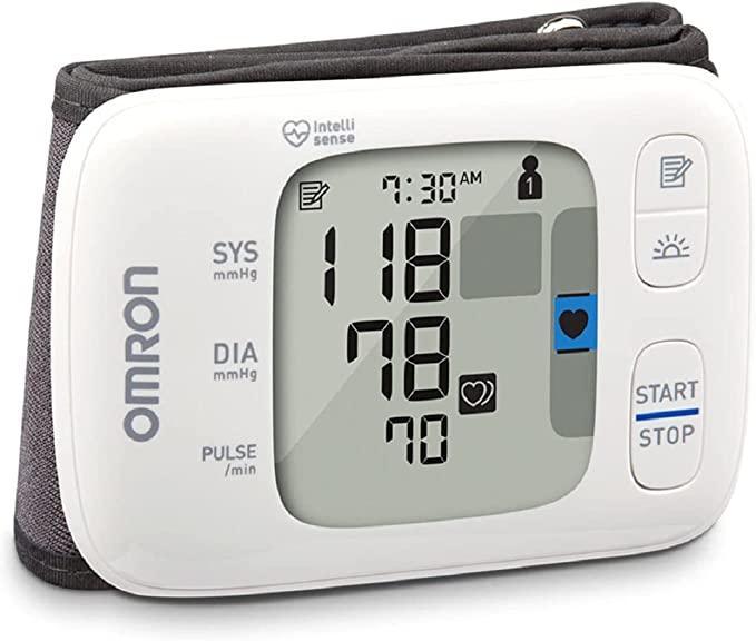 Digital blood pressure monitor with cuff, large display showing systolic, diastolic, and pulse readings