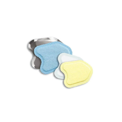 Assorted wound dressings in yellow, blue, and white on a metal tray