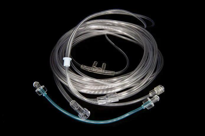 Clear medical oxygen nasal cannula tubing for respiratory therapy on a black background