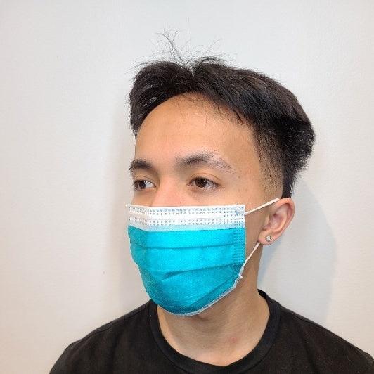 Man wearing a blue level 3 medical face mask for health protection