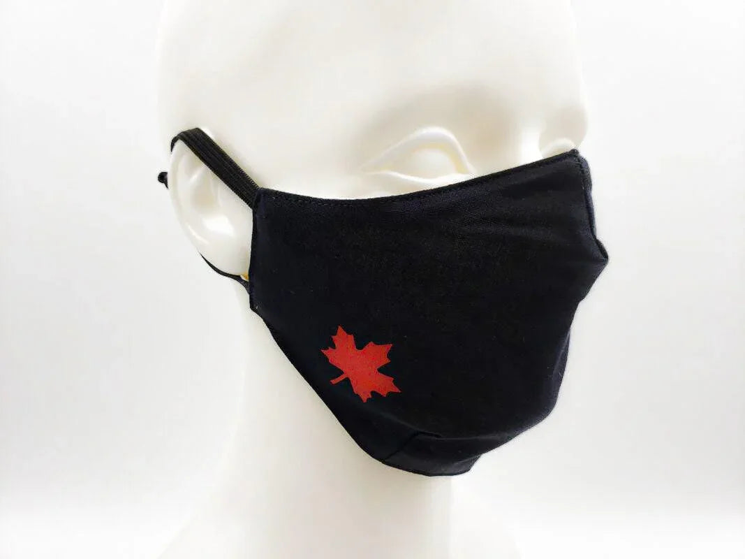 Black cotton face mask with red maple leaf, adjustable ear loops, on white mannequin