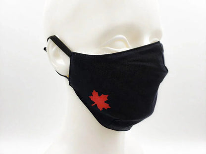 Black cotton face mask with red maple leaf, adjustable ear loops, on white mannequin
