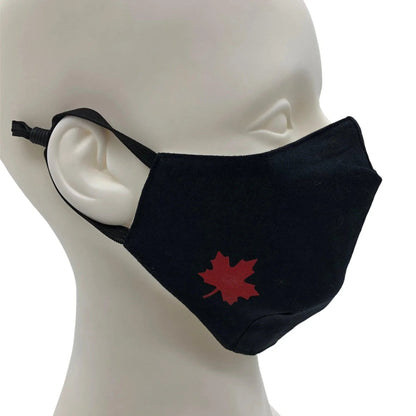 Black cotton face mask with red maple leaf design on mannequin head, adjustable ear straps