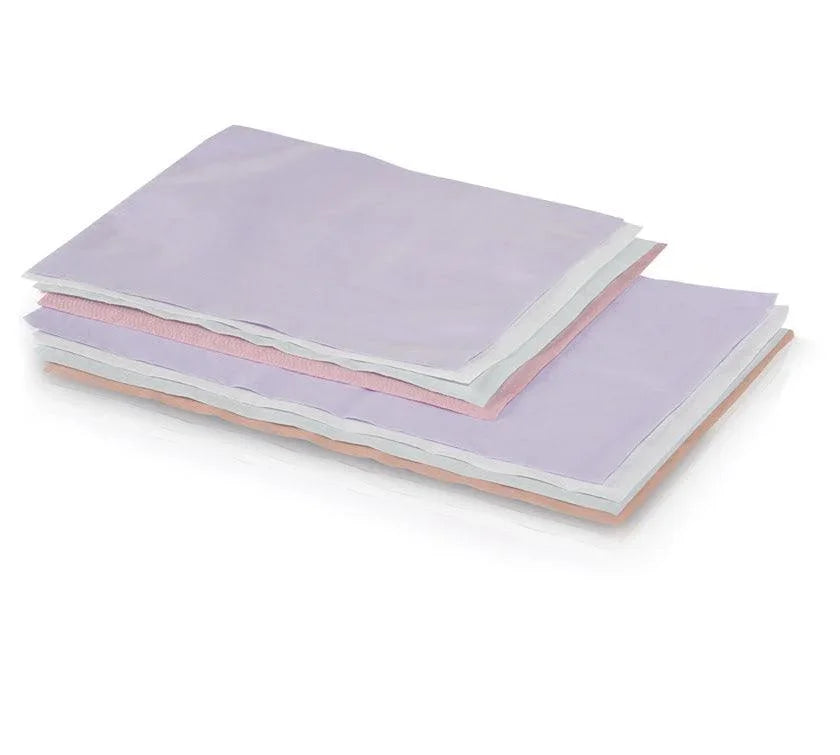 Stack of white disposable headrest covers tissue poly 10x13 for medical or spa use