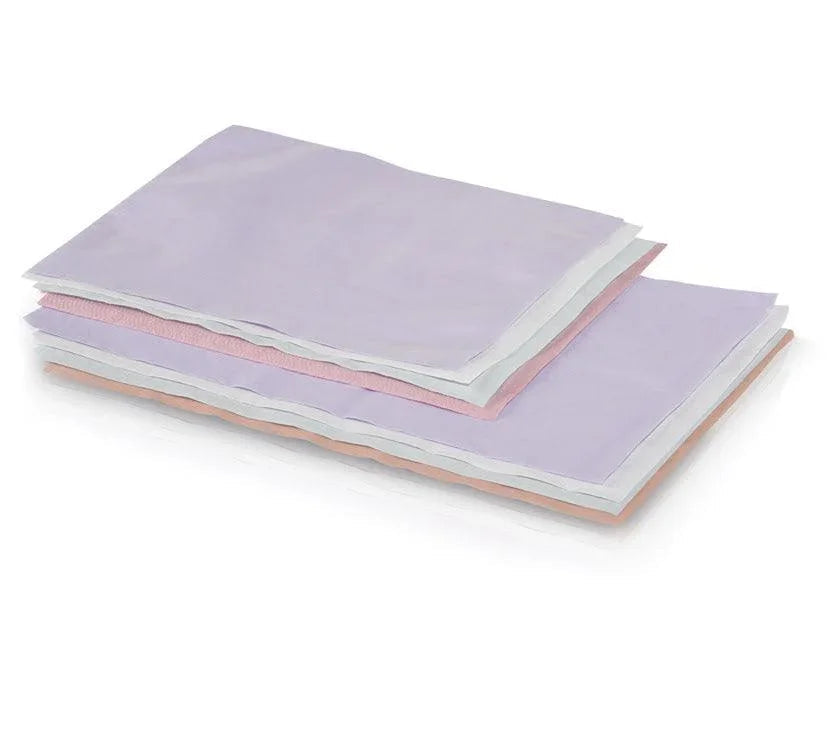 Stack of white disposable headrest covers tissue poly 10x13 for medical or spa use