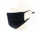 Tuck-pleated black cotton face mask with ear loops displayed on a white mannequin